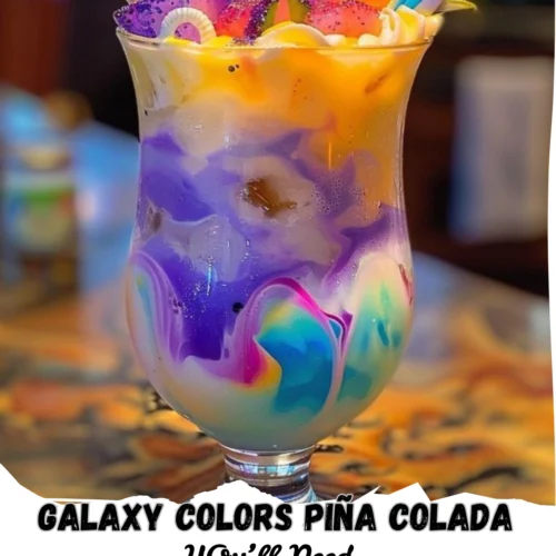Galaxy-themed Piña Colada served in a curved glass, featuring vibrant swirls of purple, blue, pink, and yellow over crushed ice. Topped with pineapple wedges, edible glitter, and festive straws, this colorful tropical drink is eye-catching and perfect for parties or summer celebrations.