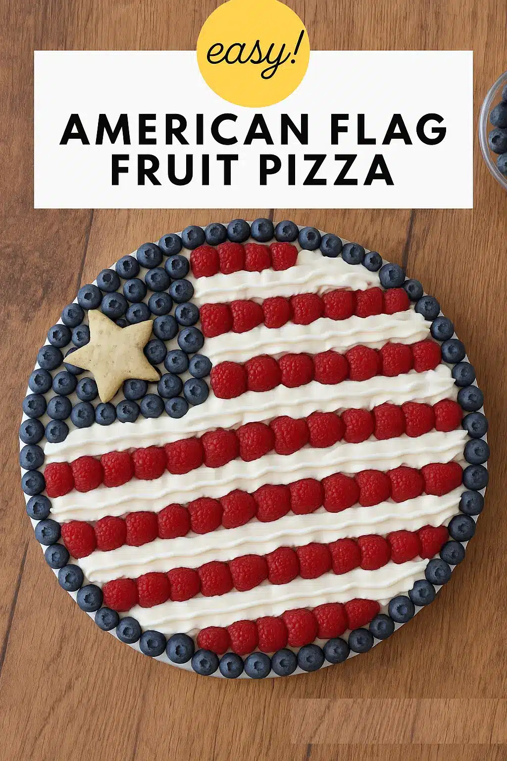 Completed American Flag Fruit Pizza with whipped cream stripes, blueberries, raspberries, and a sugar cookie star
