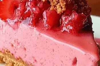 Close-up of a slice of Strawberry Crunch Cheesecake with whole glazed strawberries and golden crumb topping.