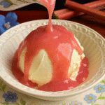 Rhubarb sauce being poured over vanilla ice cream in a floral bowl